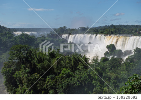 Majestic iguazu falls pouring water into lush green jungle creating awe Majestic iguazu falls pouring water into lush green jungle creating awe 139229692