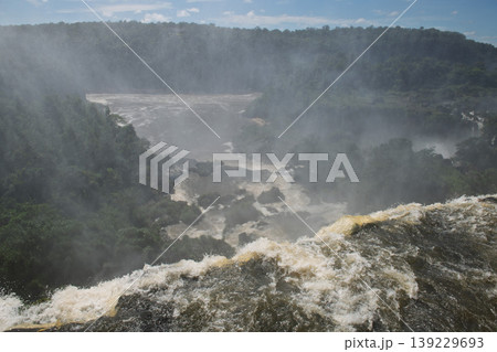 Powerful dramatic iguazu falls waterfall creating heavy mist over an awe inspiring lush gorge Powerful dramatic iguazu falls waterfall creating heavy mist over an awe inspiring lush gorge 139229693