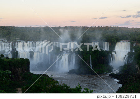 Vast iguazu falls landscape with peaceful water flowing through green nature 139229711