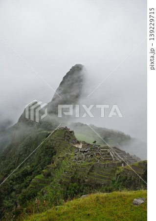 Peaceful machu picchu mountain ruin covered by mysterious deep fog Peaceful machu picchu mountain ruin covered by mysterious deep fog 139229715