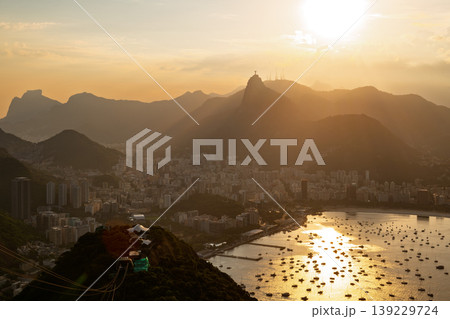 Breathtaking sunset mountain view of Rio de Janeiro beautiful city landscape over serene bay with golden light 139229724