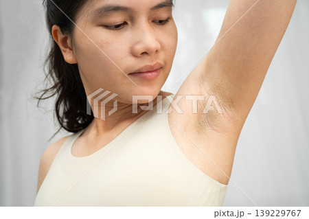 Asian woman touching her neck and throat for thyroid gland problem. Asian woman touching her neck and throat for thyroid gland problem. 139229767