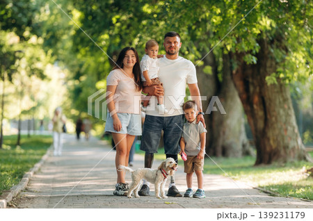Smiling, enjoying the walk. Family of father that is amputee with prosthesis, mother and two kids Smiling, enjoying the walk. Family of father that is amputee with prosthesis, mother and two kids 139231179