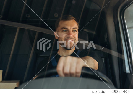 Front view of delivery man that is driving a van Front view of delivery man that is driving a van 139231409