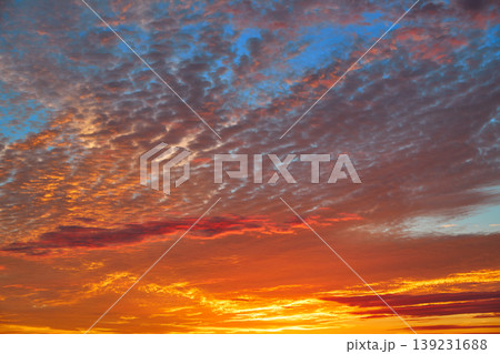 Sunset sky with orange clouds over blue Sunset sky with orange clouds over blue 139231688