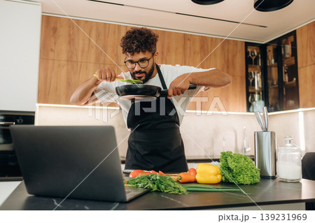 Fresh vegetables, making salad. Handsome man is preparing food on the kitchen Fresh vegetables, making salad. Handsome man is preparing food on the kitchen 139231969