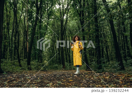 Young woman enjoying nature in the forest under the rain Young woman enjoying nature in the forest under the rain 139232244