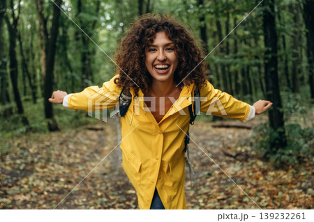 Young woman enjoying nature in the forest under the rain Young woman enjoying nature in the forest under the rain 139232261