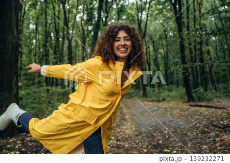 Untouched nature. Young woman is in the forest under the rain Untouched nature. Young woman is in the forest under the rain 139232271