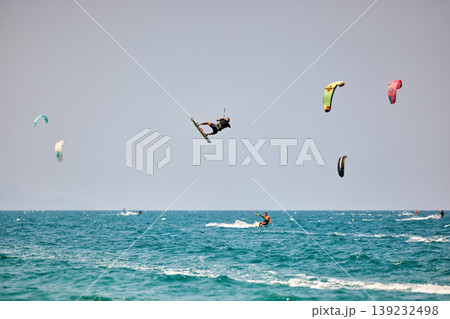 Kitesurfer High Jump Above Sea With City Background Kitesurfer High Jump Above Sea With City Background 139232498