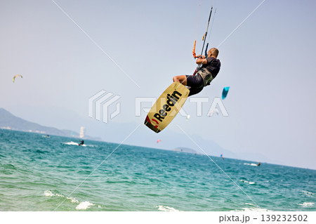 Kitesurfer High Jump Above Sea With City Background 139232502