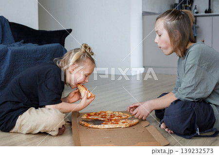 Portrait of friends girl and boy eating pizza at home Portrait of friends girl and boy eating pizza at home 139232573