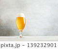 Glass pint of cold fresh lager beer with foam on light table background. 139232901
