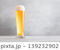 Glass pint of cold fresh lager beer with foam on light table background. 139232902