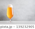 Glass of lager cold fresh preium beer with foam on light table background. 139232905