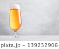 Elegant glass of lager preium beer with foam on light table background. 139232906