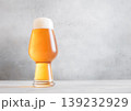 Glass of fresh craft premium lager ale beer on light table background. 139232929
