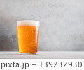 Glass of fresh craft premium lager ale beer on light table background. 139232930