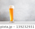 Glass of fresh craft premium lager ale beer on light table background. 139232931