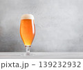 Glass of fresh craft premium lager ale beer on light table background. 139232932