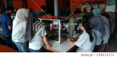 The atmosphere of the school canteen with students queuing to buy food. The atmosphere of the school canteen with students queuing to buy food. 139233171