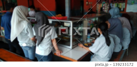 The atmosphere of the school canteen with students queuing to buy food. The atmosphere of the school canteen with students queuing to buy food. 139233172