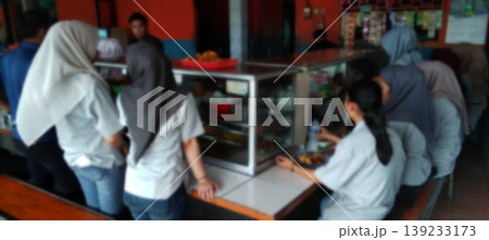 The atmosphere of the school canteen with students queuing to buy food. The atmosphere of the school canteen with students queuing to buy food. 139233173