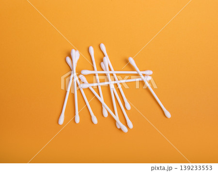 White cotton swabs on an orange background 139233553