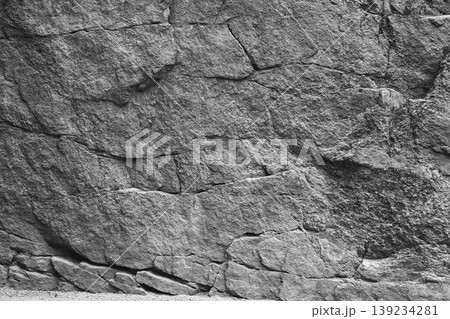 Close-up texture of a rugged grey rock face 139234281