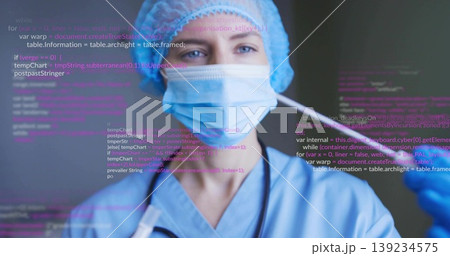 Extending technician wearing scrubs, mask and glove, showing nasal swab in lab, with code overlay Extending technician wearing scrubs, mask and glove, showing nasal swab in lab, with code overlay 139234575