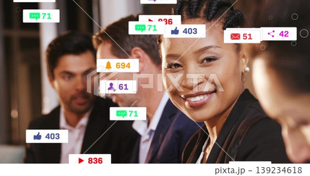Smiling woman in dark blazer analyzing social media metrics in office, with floating notifications Smiling woman in dark blazer analyzing social media metrics in office, with floating notifications 139234618