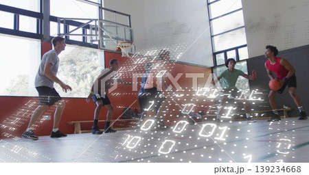 Defending basketball teammates positioning on gym court wearing uniforms, with hoop and binary code 139234668
