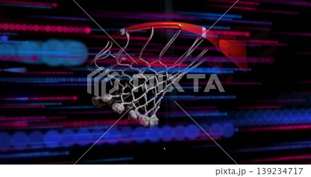 Showing basketball hoop rim and frayed net glowing in dark gym, with red-blue light streaks Showing basketball hoop rim and frayed net glowing in dark gym, with red-blue light streaks 139234717