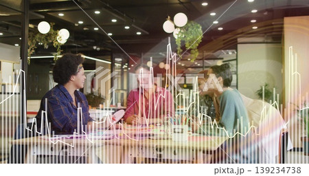 Five professionals collaborating on printed charts at table in office, with translucent overlay Five professionals collaborating on printed charts at table in office, with translucent overlay 139234738