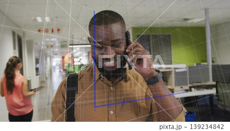 Talking smiling man holding smartphone and carrying backpack in office corridor with AR grid Talking smiling man holding smartphone and carrying backpack in office corridor with AR grid 139234842