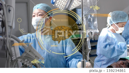 Monitoring Asian female surgeon analyzing holographic brain data in operating room with IV bag 139234861