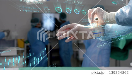 Manipulating gloved hand using holographic financial charts in operating theatre, copy space Manipulating gloved hand using holographic financial charts in operating theatre, copy space 139234862