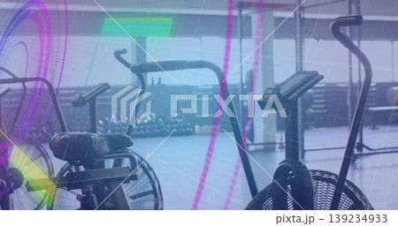 Featuring central air bike spinning fan with digital display in fitness studio, with dumbbell rack Featuring central air bike spinning fan with digital display in fitness studio, with dumbbell rack 139234933