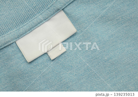 White blank laundry care clothes label on shirt fabric background White blank laundry care clothes label on shirt fabric background 139235013