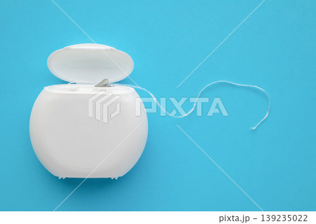 dental floss in case on blue background 139235022