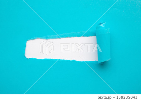 Blue torn paper rolled edge with space isolated on white background Blue torn paper rolled edge with space isolated on white background 139235043