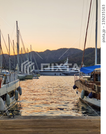 beautiful ships and boats are moored near the shore beautiful ships and boats are moored near the shore 139235163