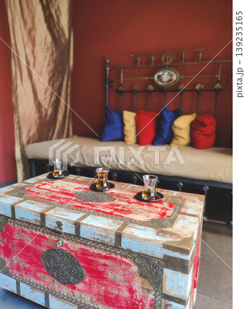 Traditional Turkish tea served on a vintage chest in a cozy interior 139235165