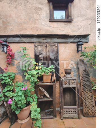 Rustic outdoor display with vintage wooden shutters and potted geraniums in Turkey 139235204