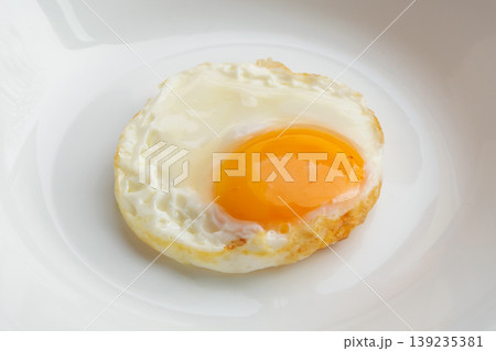 Fried egg on white dish close up Fried egg on white dish close up 139235381