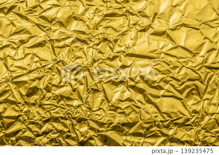 Luxury shiny metallic golden foil crumpled texture background Luxury shiny metallic golden foil crumpled texture background 139235475
