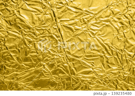 Luxury shiny metallic golden foil crumpled texture background Luxury shiny metallic golden foil crumpled texture background 139235480