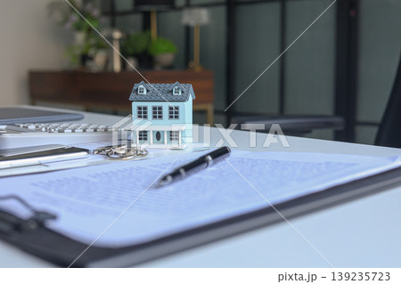 Signing contract for housing. Concept for real estate investment, home buying, selling, insurance, loan, lease, mortgage Signing contract for housing. Concept for real estate investment, home buying, selling, insurance, loan, lease, mortgage 139235723