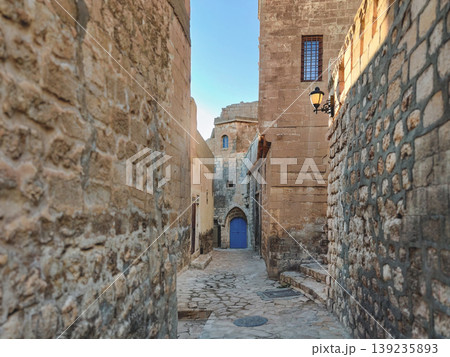 Ancient narrow street in Mardin with traditional stone houses 139235893