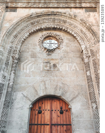 Ornate stone portal and wooden door of an ancient building in Mardin Ornate stone portal and wooden door of an ancient building in Mardin 139235895